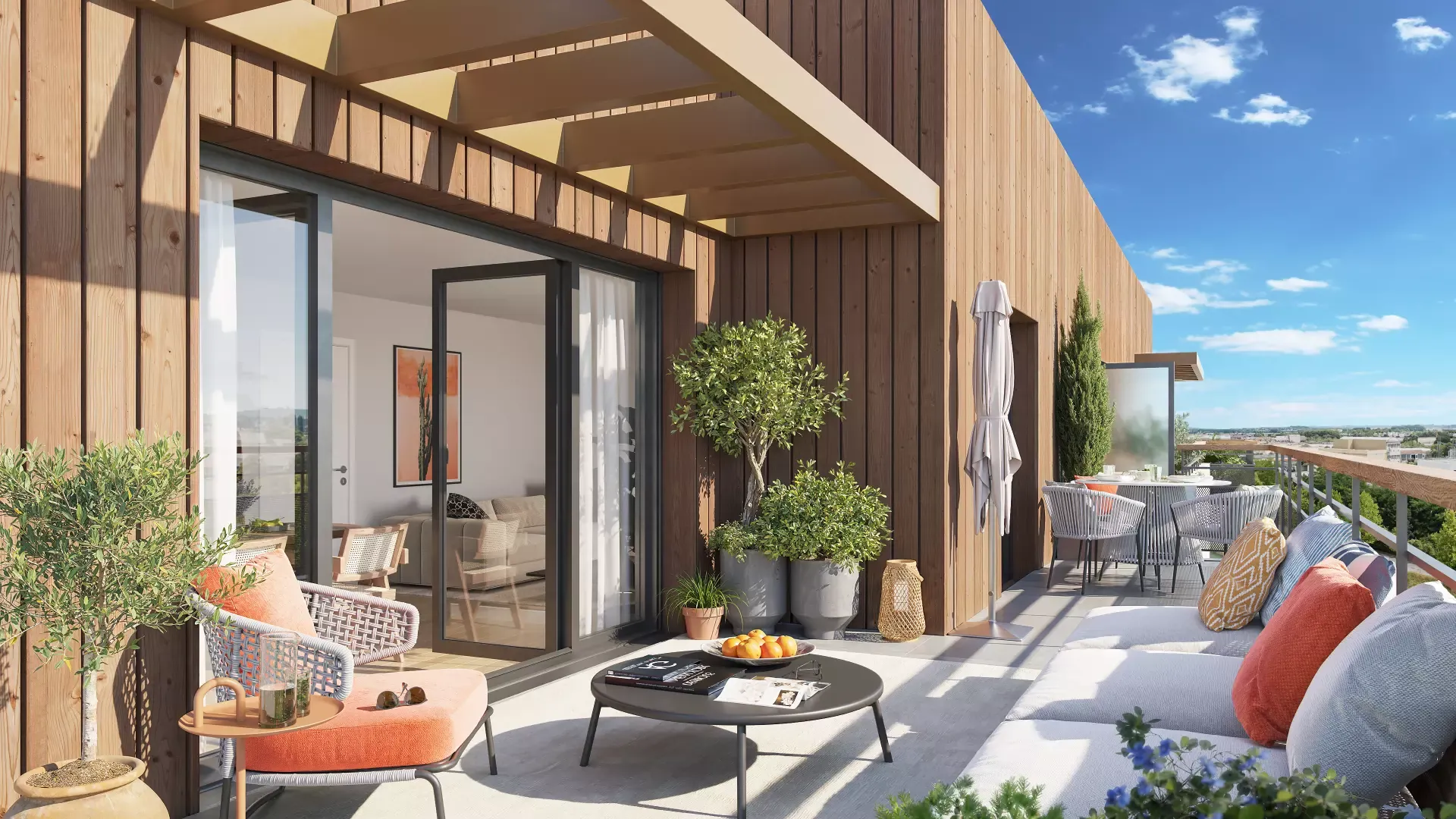 Une terrasse en attique avec salon de jardin, ouverte sur le séjour par une grande baie vitrée.